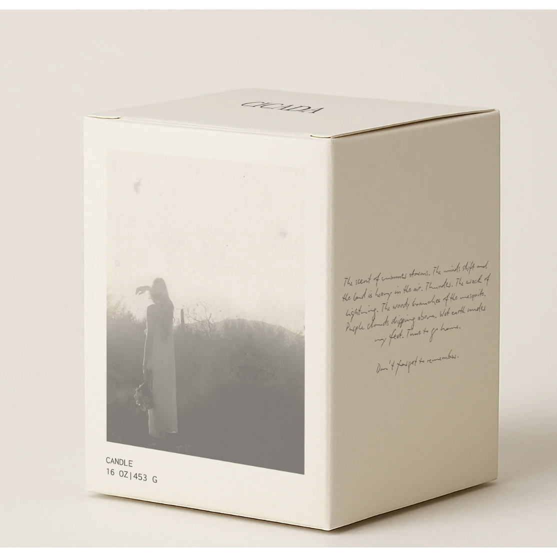 White candle box with a black and white photo and text on a light background