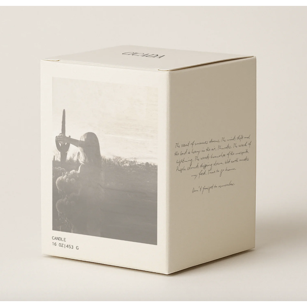 White candle box with black and white photo and text on a light gray background