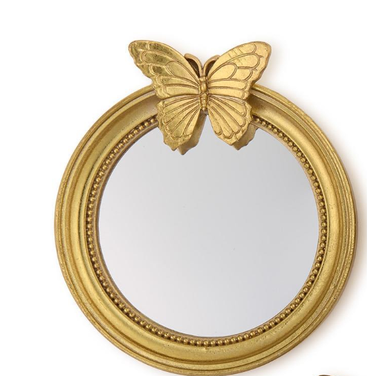 Gold butterfly decorative mirror on a white background