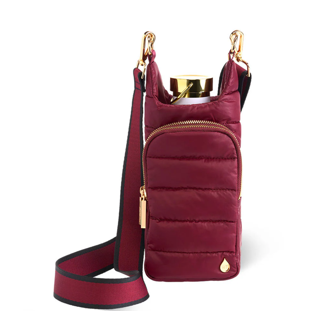 Maroon quilted handbag with gold accents on a white background
