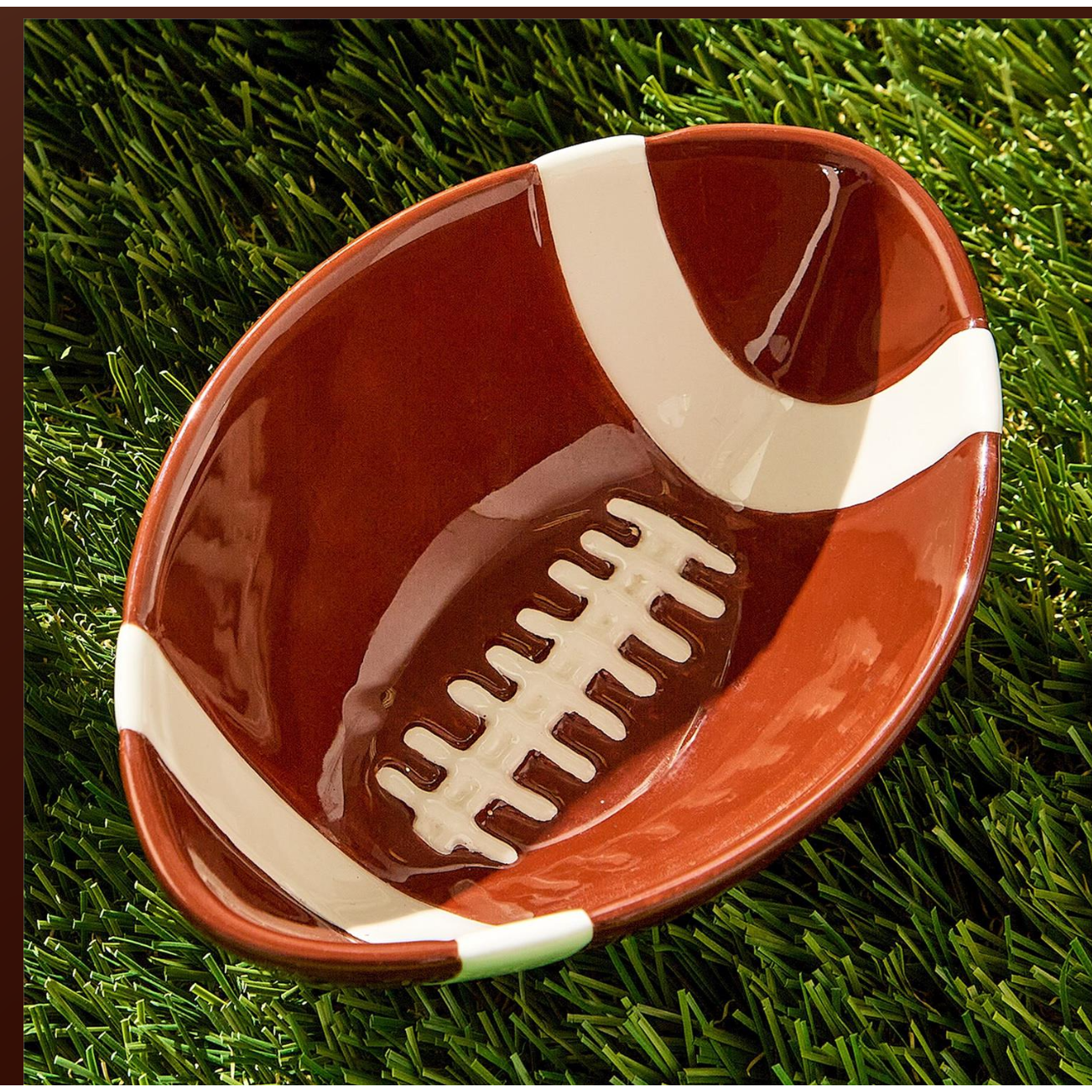 Ceramic football-shaped bowl on a grass background