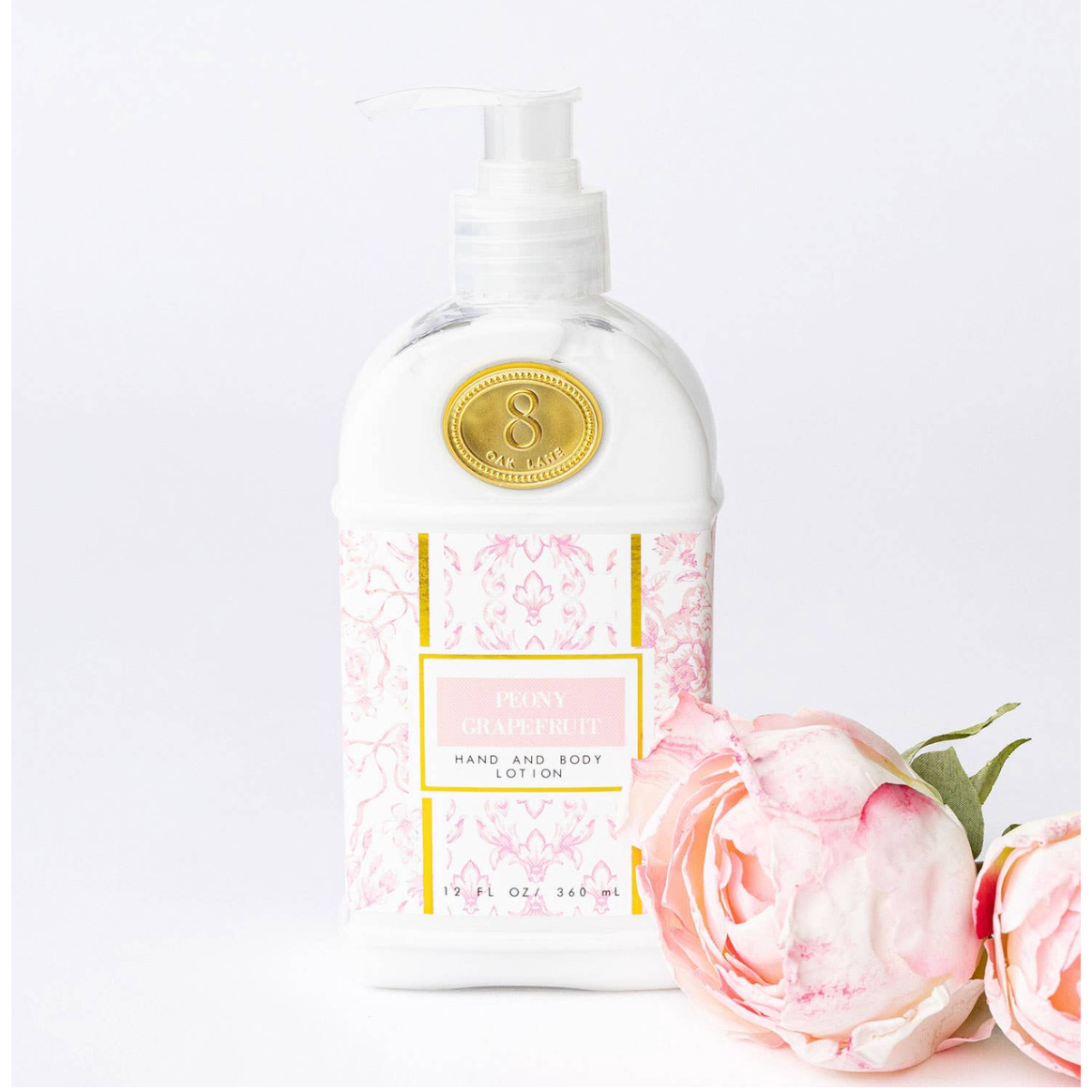 Hand and body lotion bottle with floral design on a white background