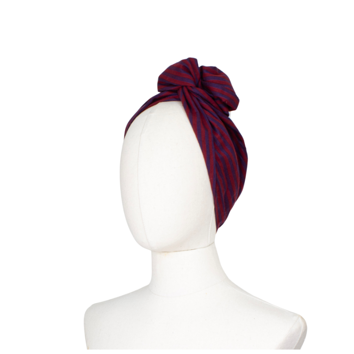A knotted headwrap or turban-style hair accessory in deep burgundy with thin navy stripes, displayed on a white mannequin head against a plain white background.