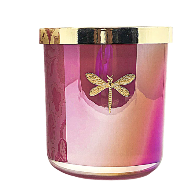 Candle with a gold lid and dragonfly design on a white background