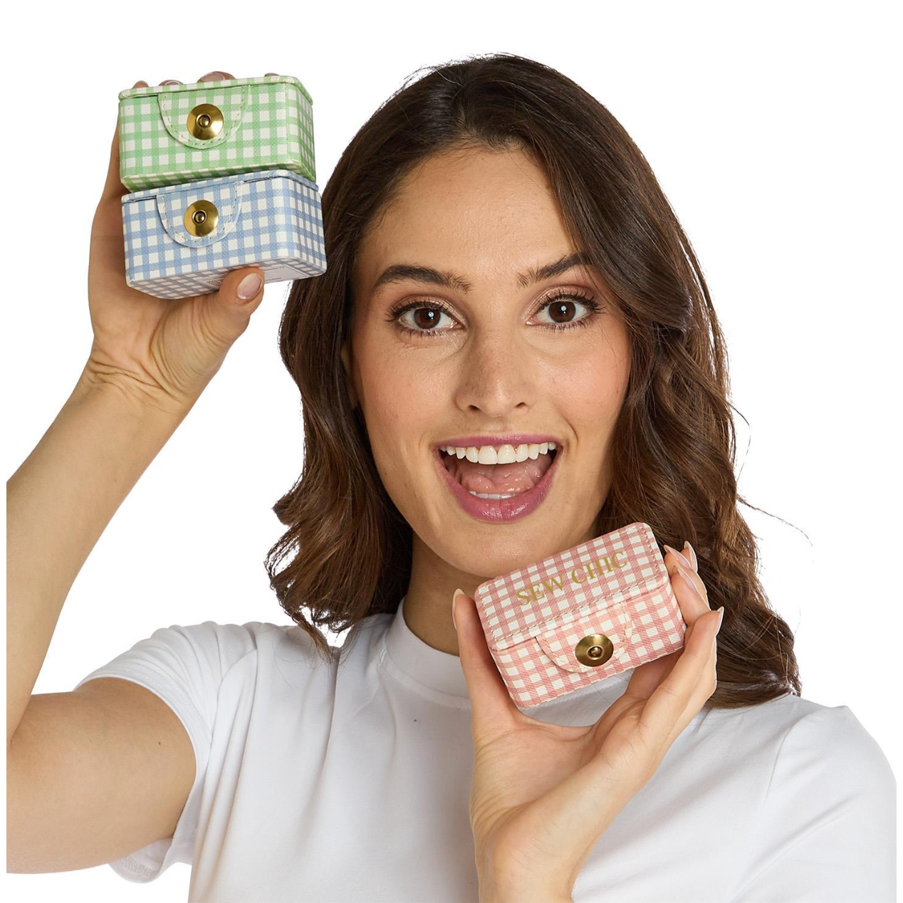 Woman holding two small checkered boxes, one on each side of her head, against a white background.