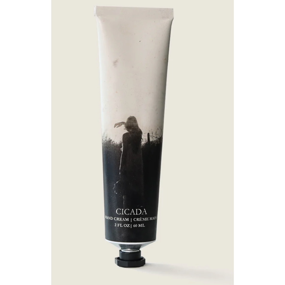 Tube of Cicada hand cream with a black and white design on a beige background