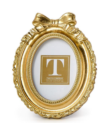 Gold ornate picture frame with a bow on a white background