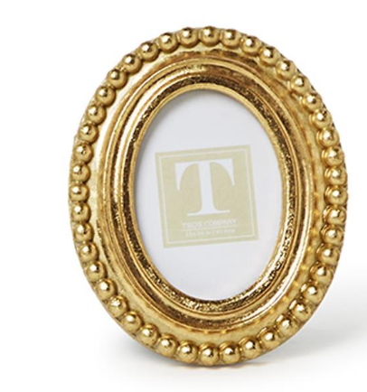 Gold oval picture frame with decorative beads on a white background