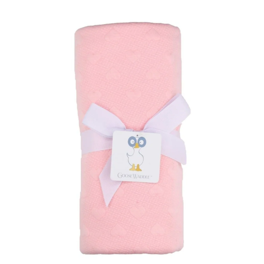 Pink blanket with a white bow and a brand label on a white background