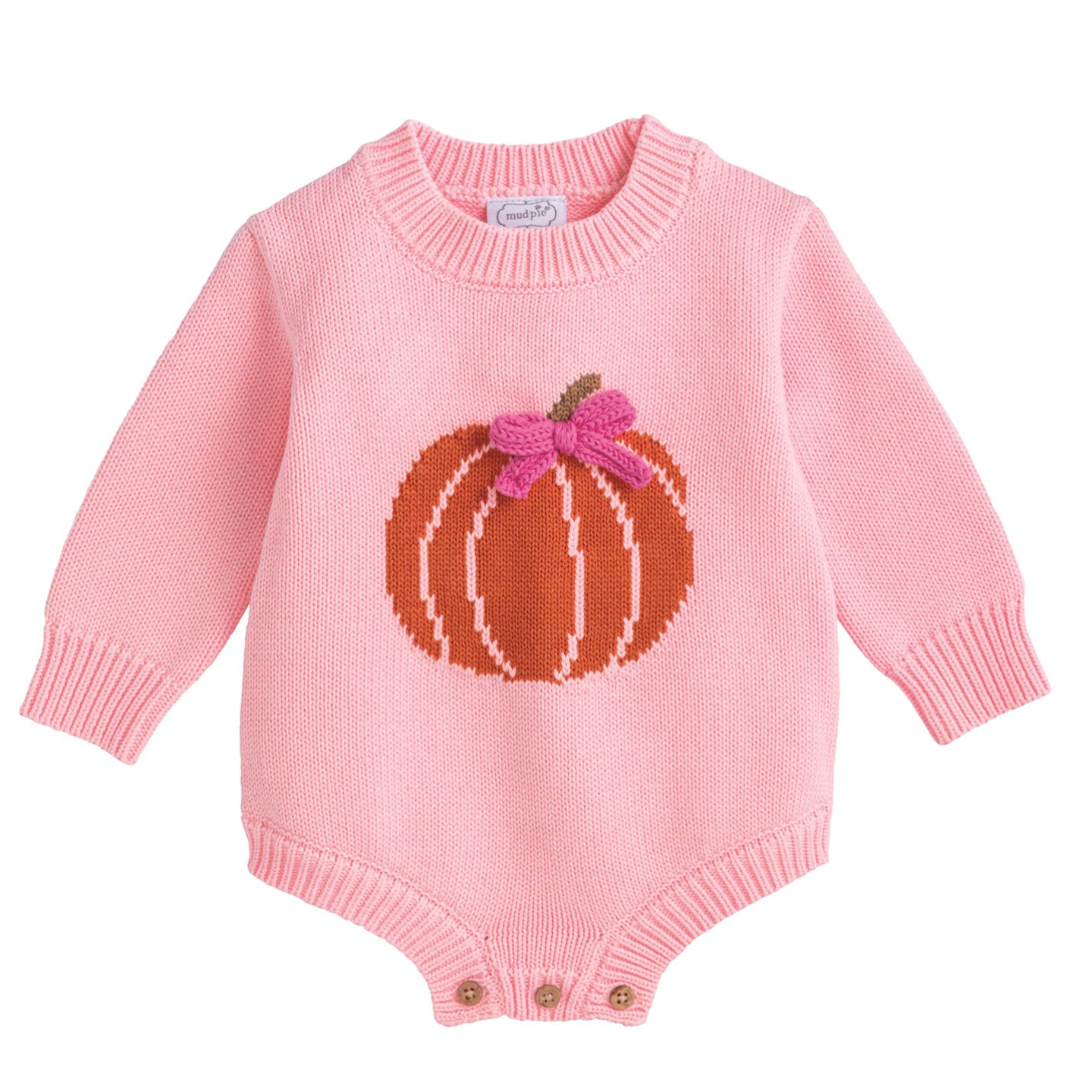 Pink knitted baby romper with pumpkin design on a white background