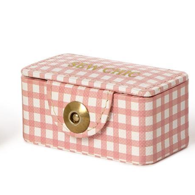 Pink and white checkered jewelry box with a gold clasp on a white background