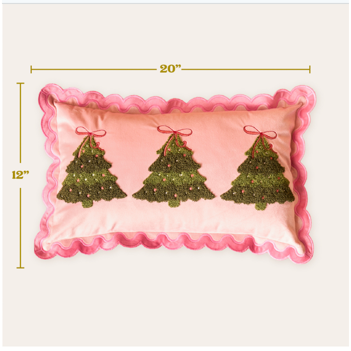 A pink rectangular decorative pillow with scalloped pink trim and three green embroidered Christmas trees across the front, shown on a light background with dimension lines indicating 20 inches by 12 inches.