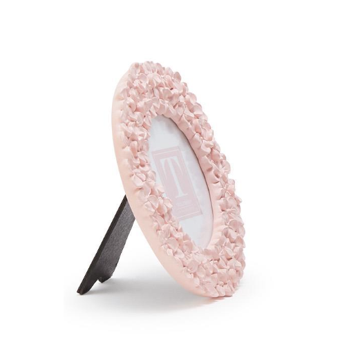 Pink decorative mirror with textured frame on a white background