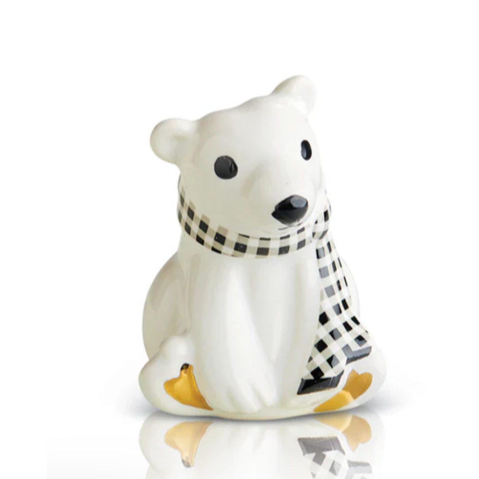White ceramic bear figurine with a black and white checkered scarf on a white background