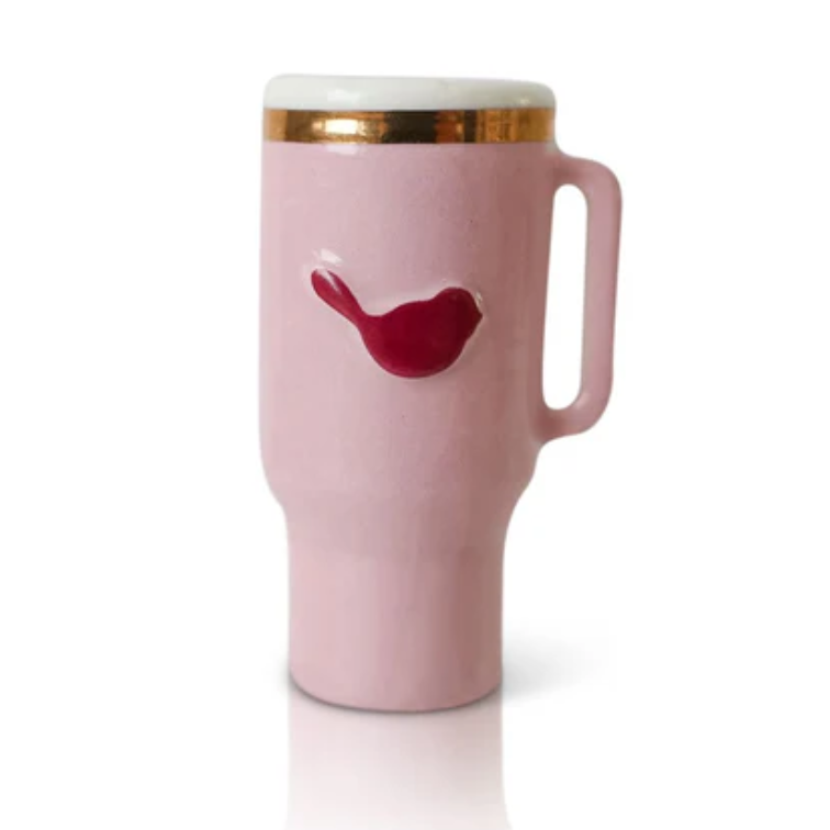 Pink mug with a red bird design on a white background