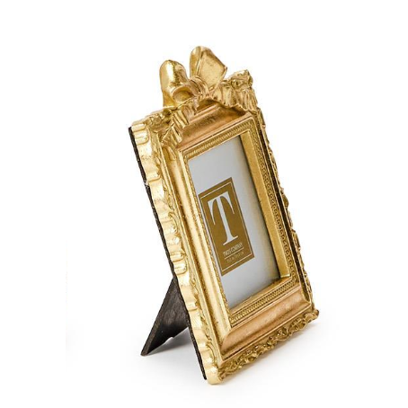 Gold decorative picture frame with a white card inside on a white background