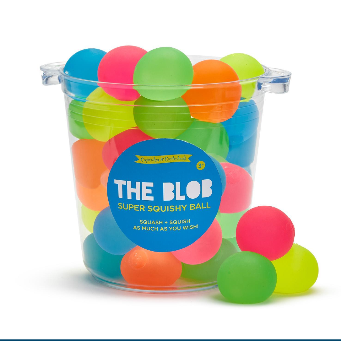 Clear container filled with colorful 'The Blob' super squishy balls on a white background
