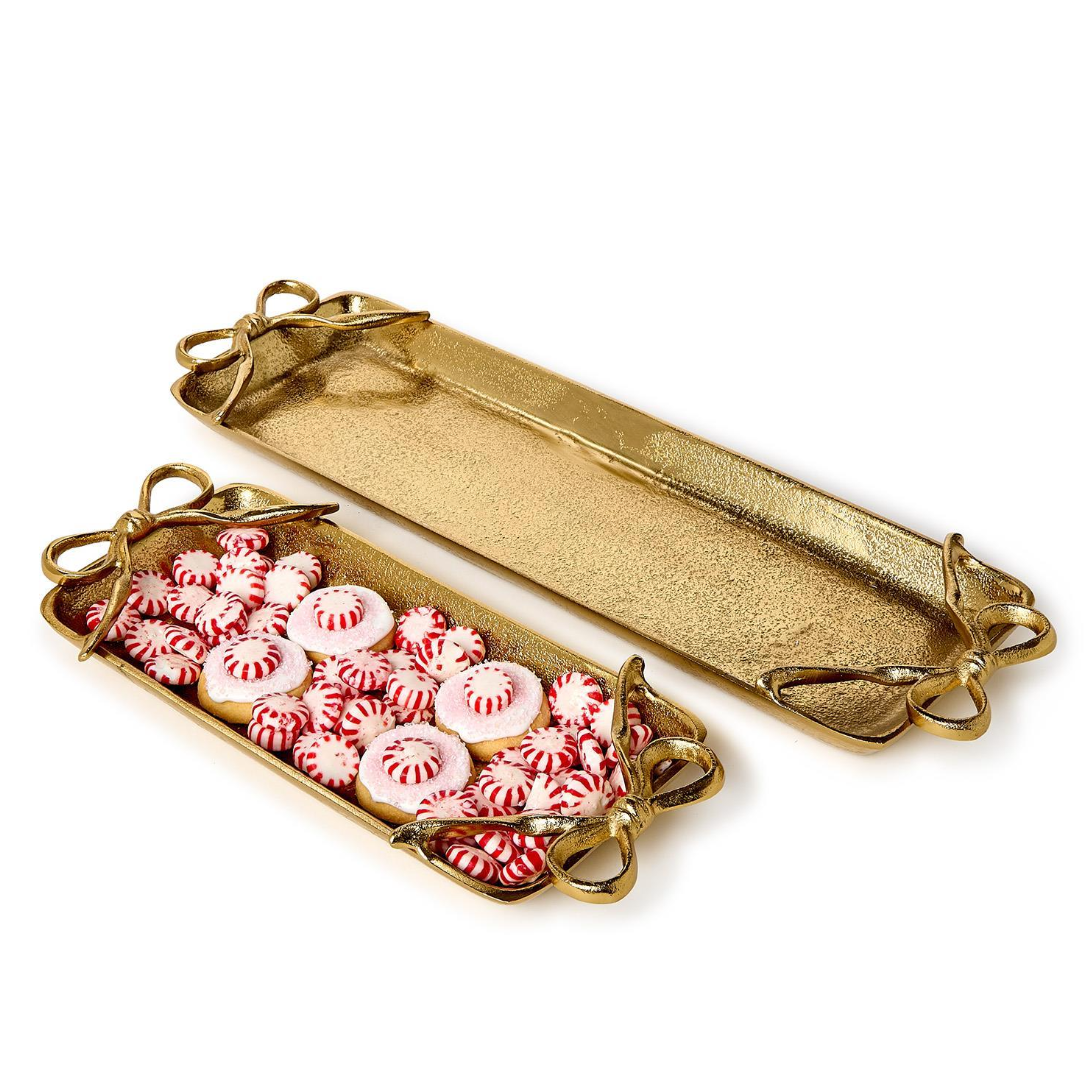Gold decorative tray with pink and white candies on a white background