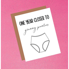 Card with text 'One year closer to granny panties' on a pink background
