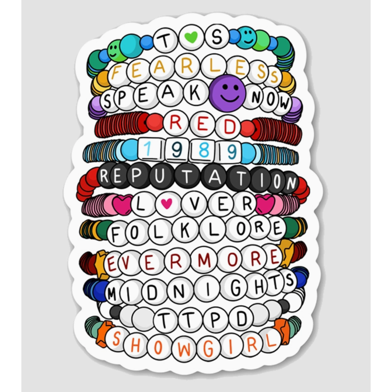Colorful vinyl stickers with text and designs on a gray background