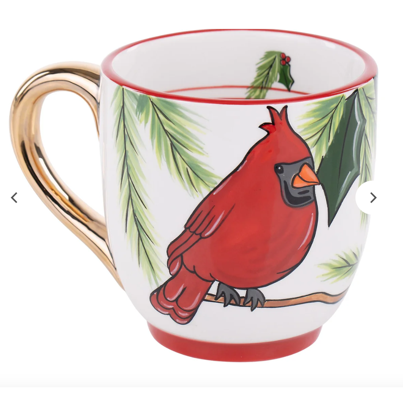 Mug with a red cardinal and green leaves design on a white background