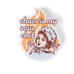 Sticker with a design of a woman and text 'chaos is my sous chef' on an orange and white background.