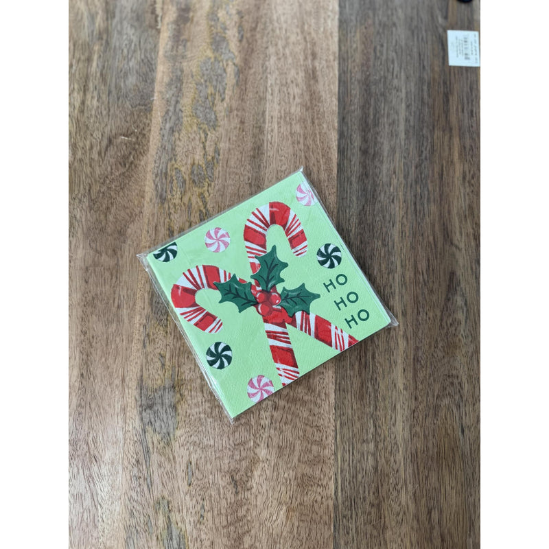 Christmas-themed notepad with candy canes and 'HO HO HO' text on a wooden surface