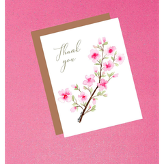 Greeting card with cherry blossom design and 'Thank you' text on a pink background