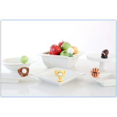 Set of white ceramic bowls with decorative handles on a white background