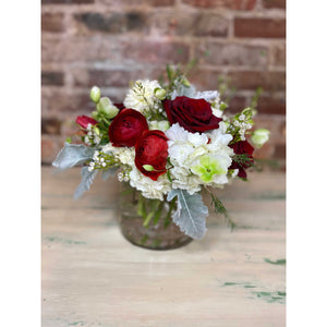 red roses and ranunculus with hydrangeas