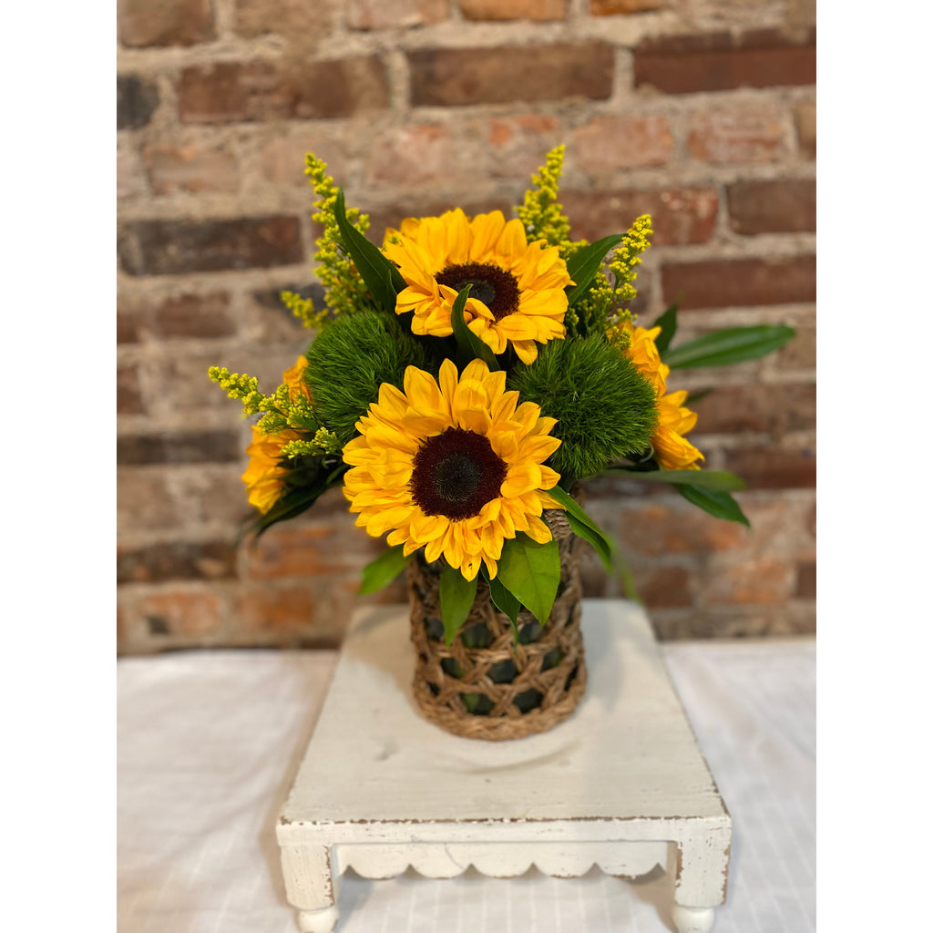Sunflowers in Wicker Hurricane Vase.